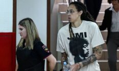 Brittney Griner wears white t-shirt as she is led out in handcuffs to a trial hearing in Russia