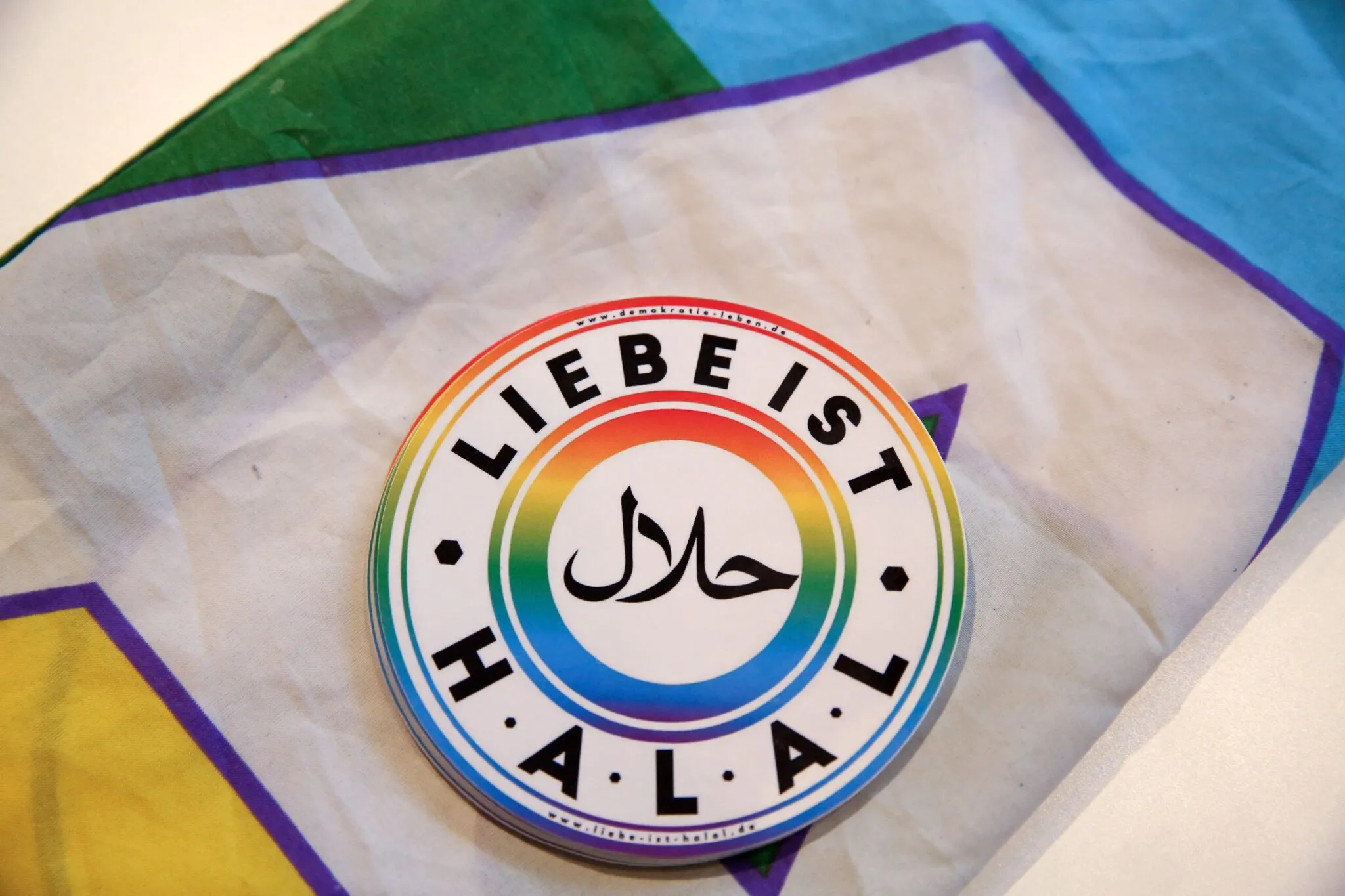 A sticker reading "Love is Halal" lies atop a rainbow flag inside the Ibn Rushd-Goethe mosque in Berlin after a larger rainbow flag was hung on the building's exterior wall in Berlin, Germany on July 1, 2022.