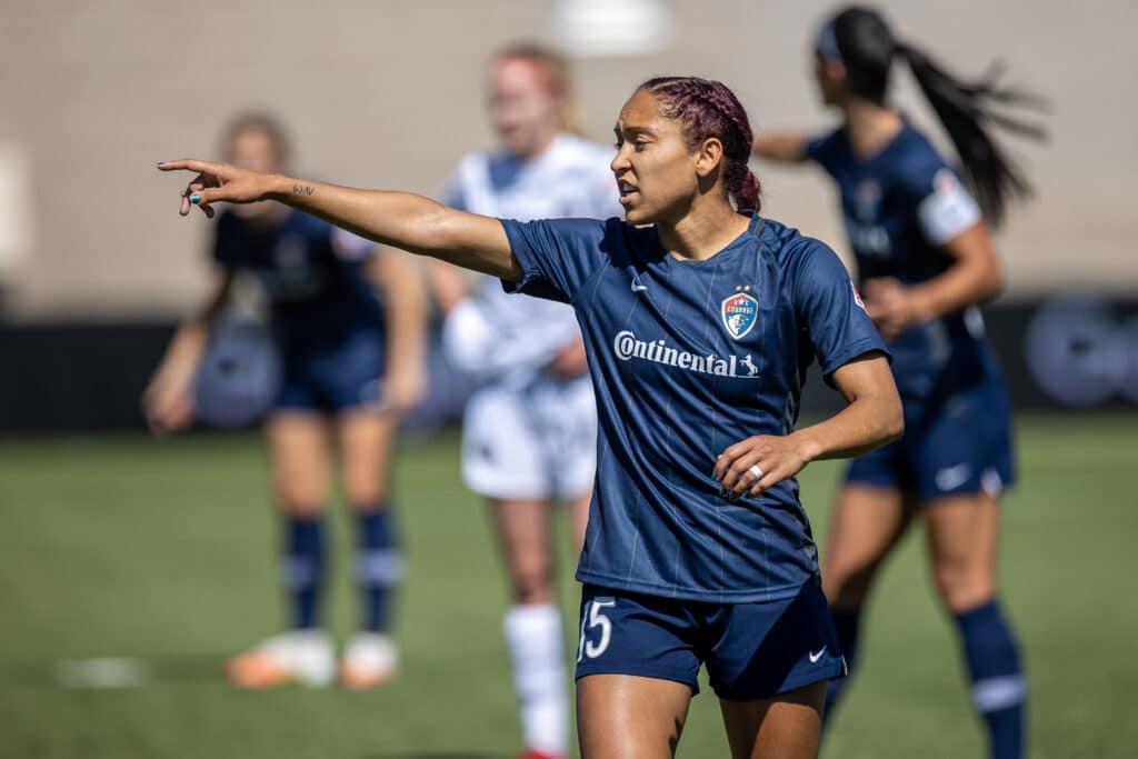Jaelene Daniels of North Carolina Courage instructs team during a game