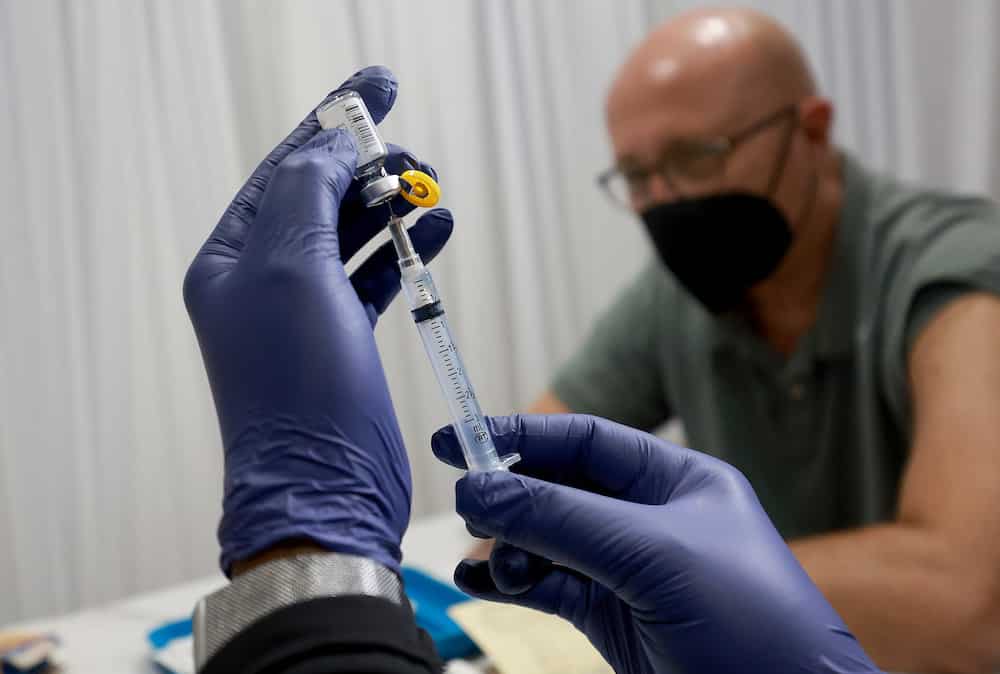 A healthcare worker prepares to administer a monkeypox vaccine in Florida