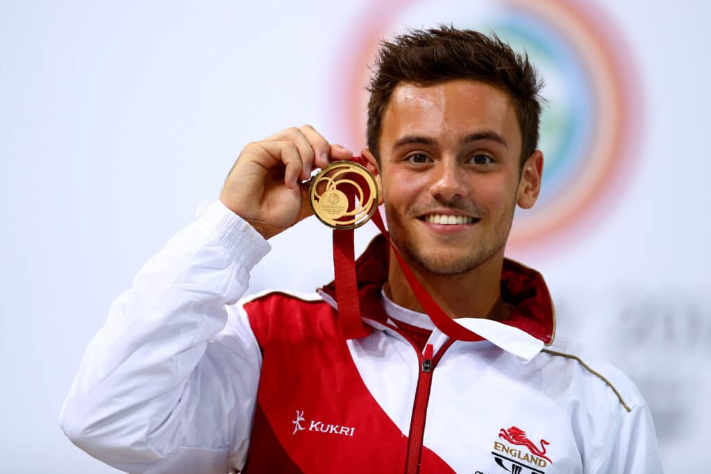 Tom Daley of England celebrates on the podium after winning the Gold medal in the Men's 10m Platform Final at the Royal Commonwealth Pool during day ten of the Glasgow 2014 Commonwealth Games on August 2, 2014 in Edinburgh, United Kingdom.