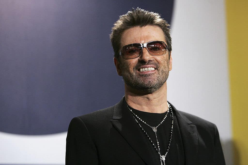 George Michael poses at the "George Michael: A Different Story" Photo call. 
