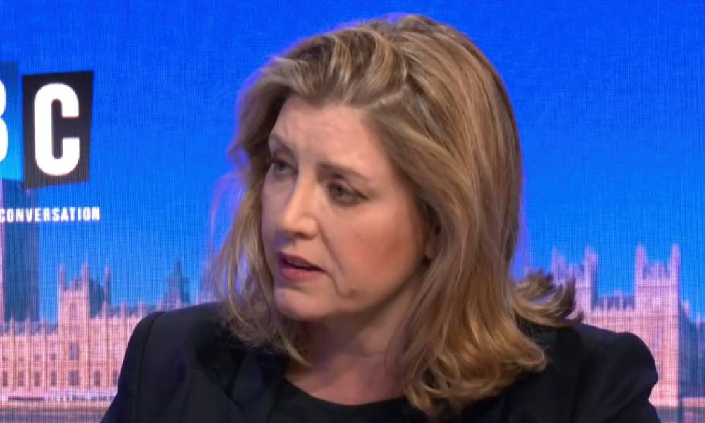 Penny Mordaunt wears a dark outfit as she talks to someone off screen during an interview on LBC