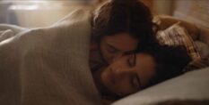 Tanya Reynolds and Seyan Servan as Helen and Nour in The Baby in bed together. (HBO/Sky)