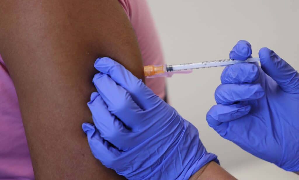 Doctor administers a dose of the monkeypox vaccine into a person's arm