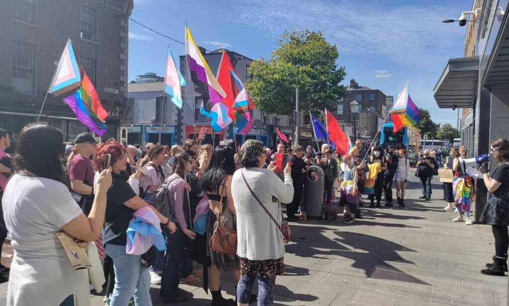 A crowd of LGBTQ+ activists and allies gather outside the Independent House