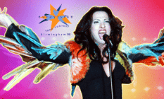 Dana International singing in front of the Eurovision 98 logo