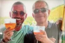 Walter Biot (left) and Uwe Hahn (Right) hold up drinks together.