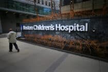 In this photograph, a pedestrian passes the Longwood Avenue exterior of the Boston Children's Hospital