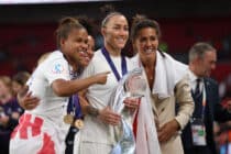 Lionesses Nikita Parris, Demi Stokes, Lucy Bronze and Fara Williams pose with the trophy after the UEFA Women's Euro England 2022 final match between England and Germany