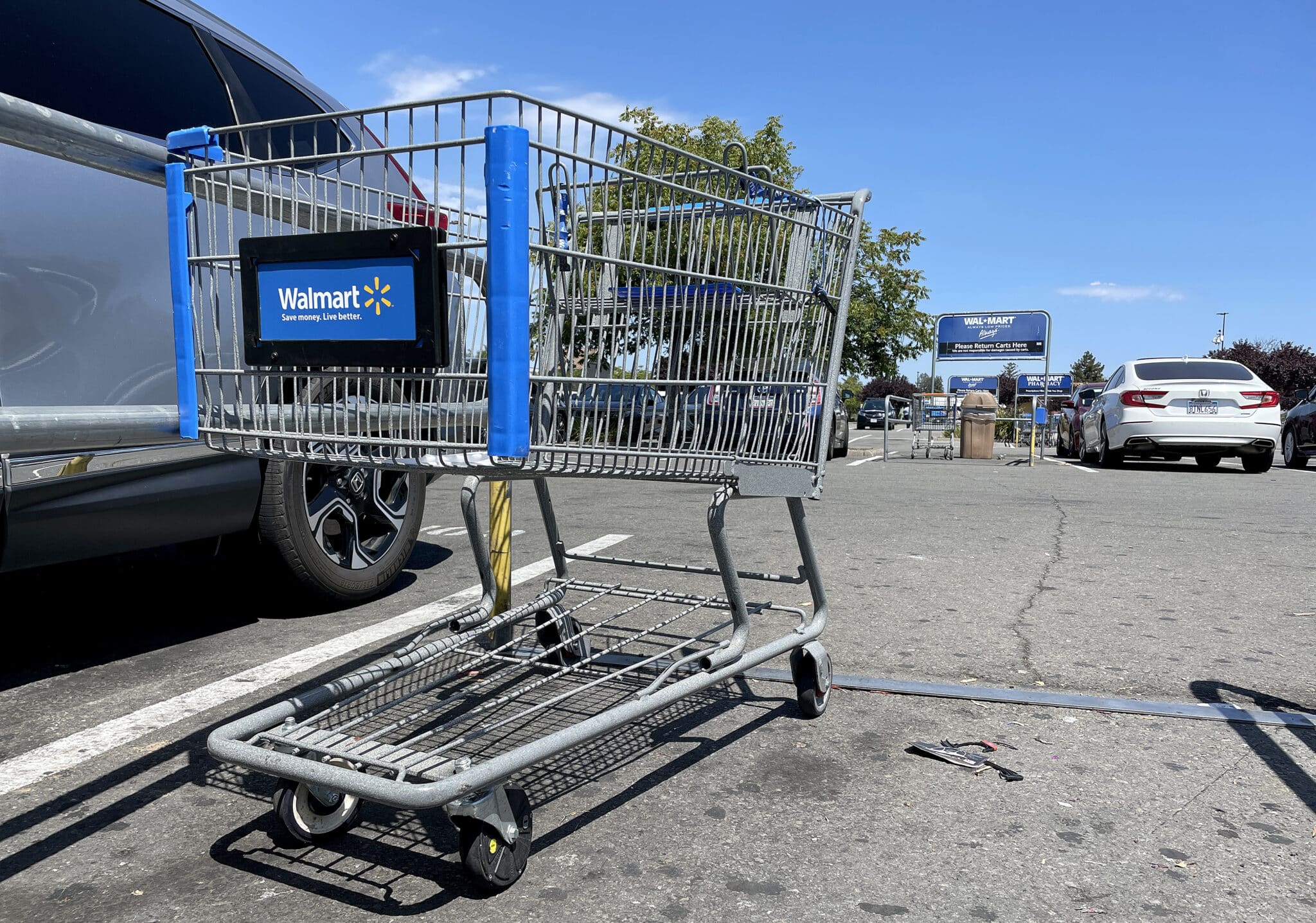 Shopping carts sit in the parking lot of a Walmart store