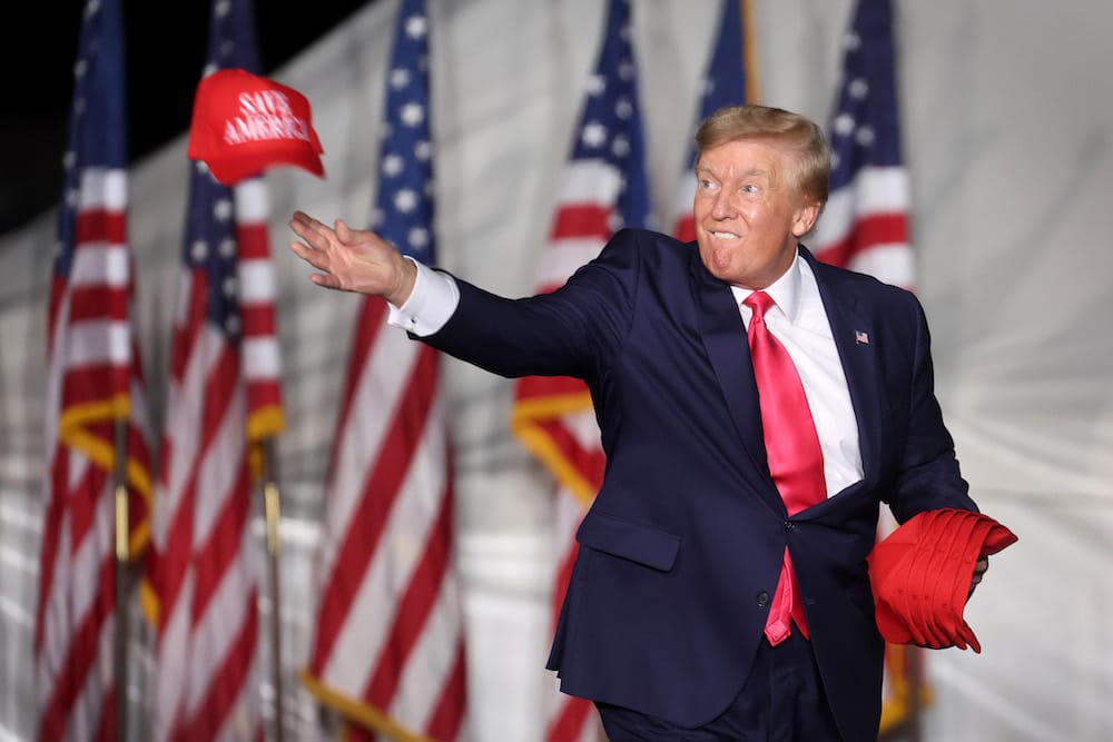 Donald Trump tosses hats to supporters at the rally Waukesha, Wisconsin