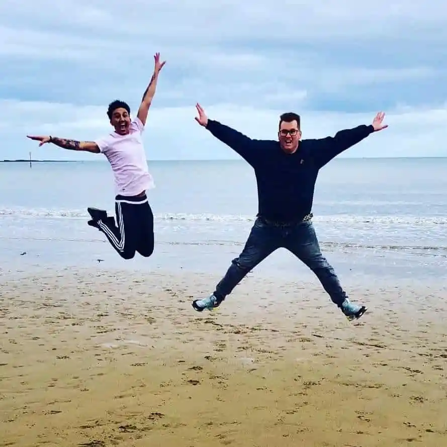Paul and Michael Atwal-Brice pictured jumping in the air on the beach.