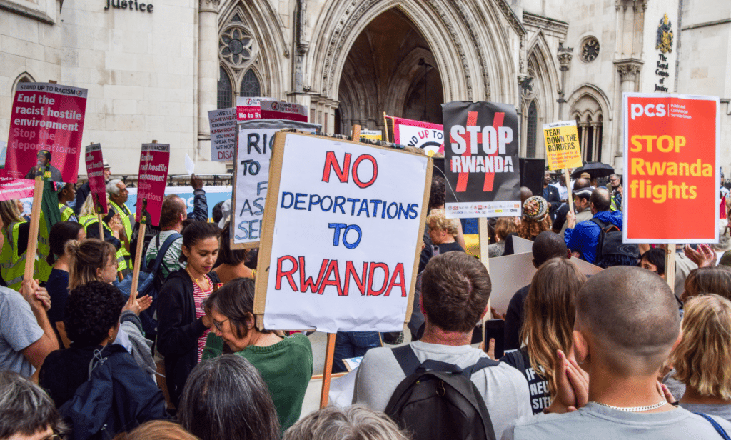 People gather outside the High Court to protest against Priti Patel's Home Office policy to deport asylum seekers to Rwanda